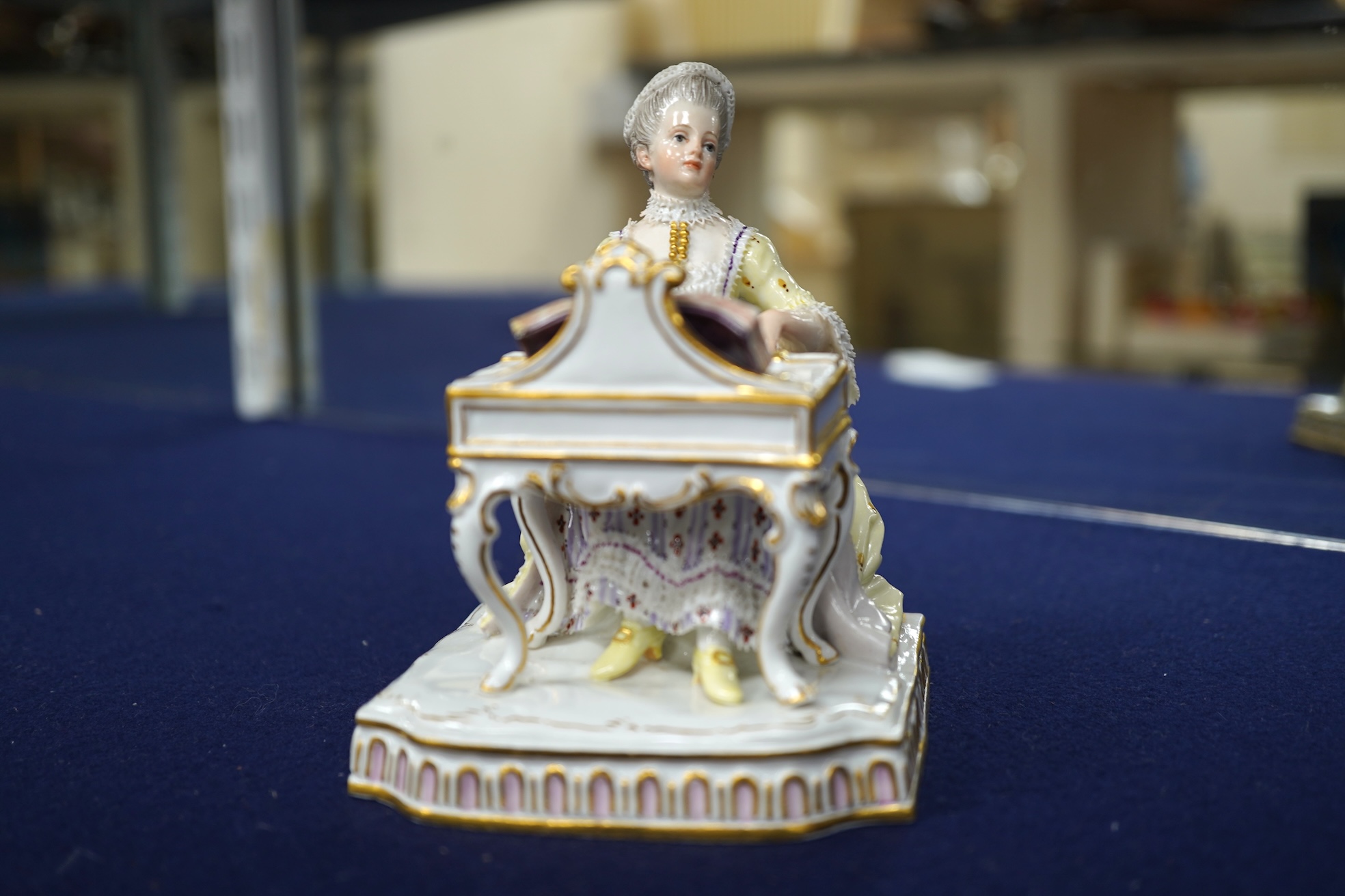 A pair of 19th century Meissen figures of a girl holding a shell and a boy holding a book, in size model number 628, tallest 13cm